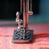 Illustration representing a detailed sewing machine stitch line on fabric, indicating garment manufacturing service.